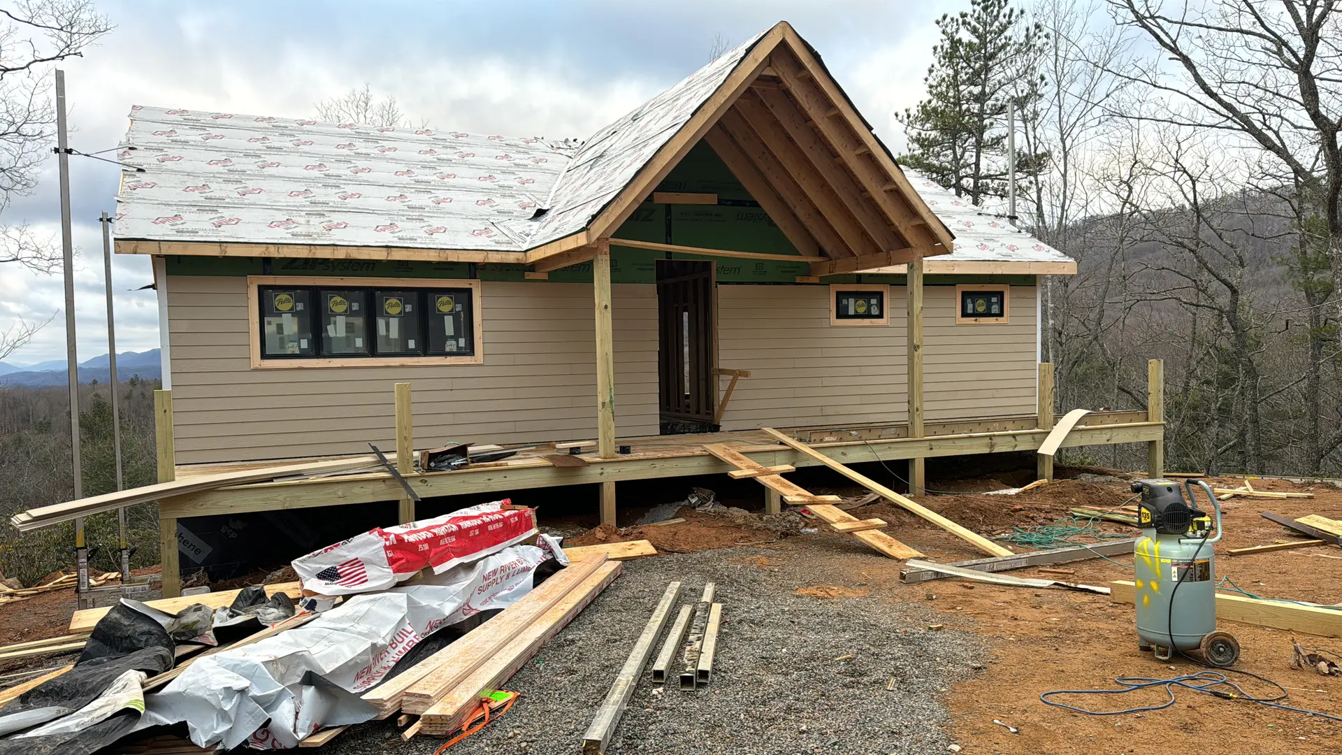 Plan-built home with tan siding and a covered porch