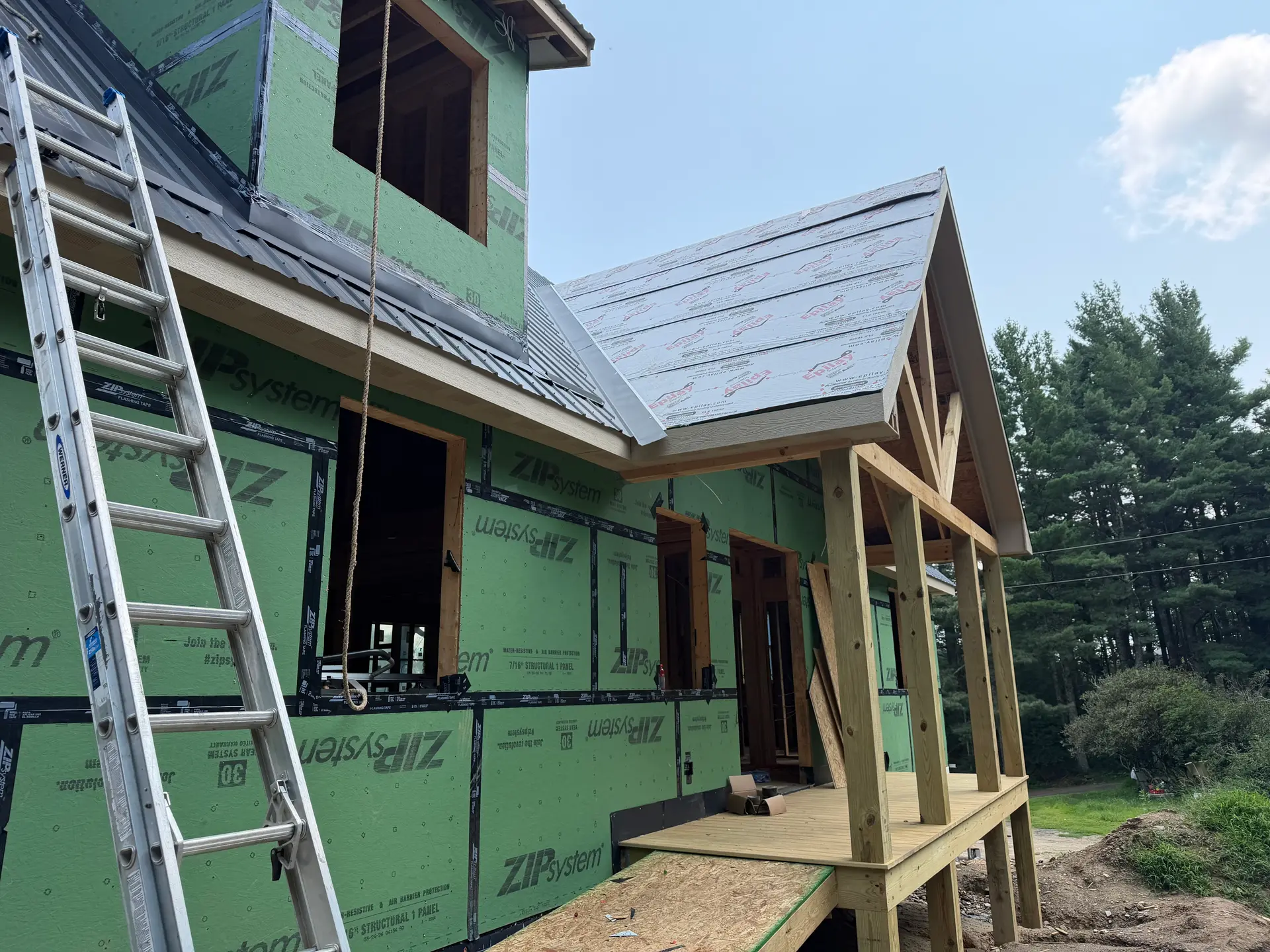 Home in the sheathing phase with a timber porch
