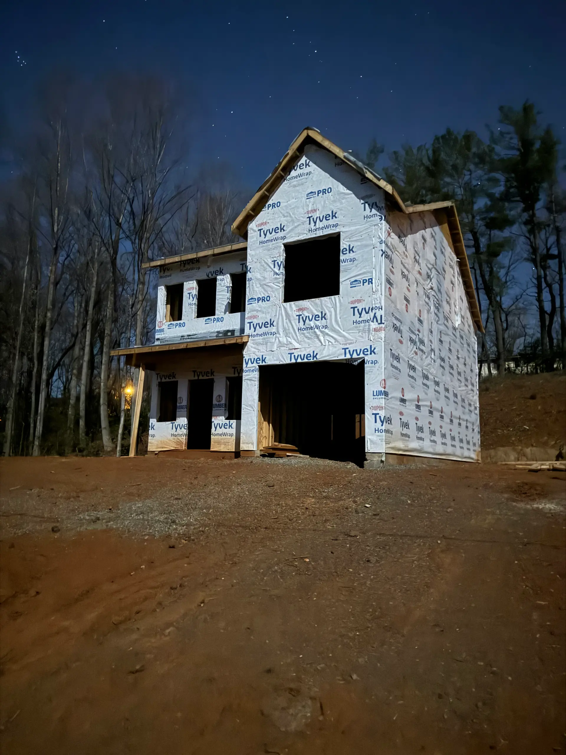 Two-story residence wrapped and framed on a sloped lot